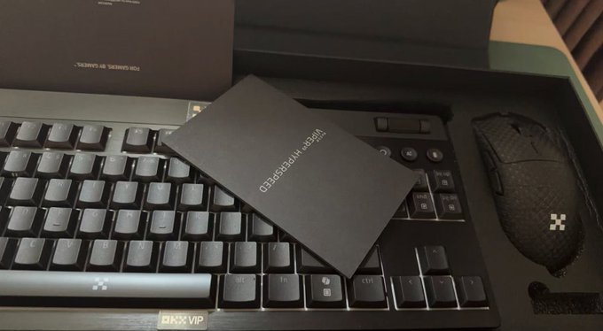 A high-end gaming setup with an ICI SWISS GAMER keyboard, a mouse, and a 'VIEWSHARE HOLOGRAPHIC' external drive resting on the keys.