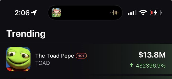 The image shows a crypto trading app's "Trending" section displaying "The Toad Pepe" (TOAD) token with a market cap of $13.8M and an astronomical gain of 432,396.9%, marked as "HOT."

This screenshot illustrates the post's humorous caption about watching crypto influencer Mike Dudas pump a meme coin from zero to $14M while multitasking with a baby, perfectly capturing the absurd wild ride of the memecoin trenches.
