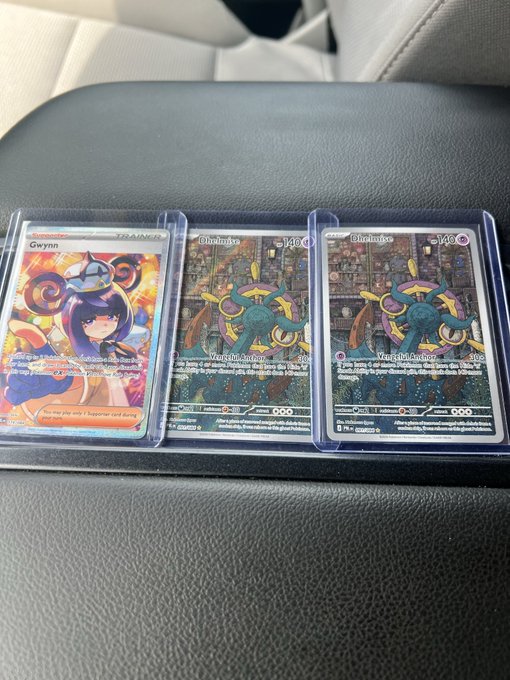 Three Pokémon trading cards are displayed in protective sleeves on a dark gray surface: a "Gwynn" Trainer card (137/159) on the left and two identical "Glimmora" cards (146/??) on the right, likely representing recent trades the user picked up during their lunch break before testing the Grotto feature.