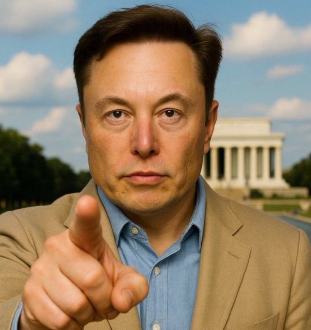 A man in a tan blazer pointing toward the camera with the Lincoln Memorial visible in the background.