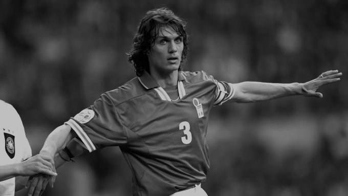 Black and white photo of a soccer player wearing a jersey with the number 3, with long hair, extending his arm during a match.