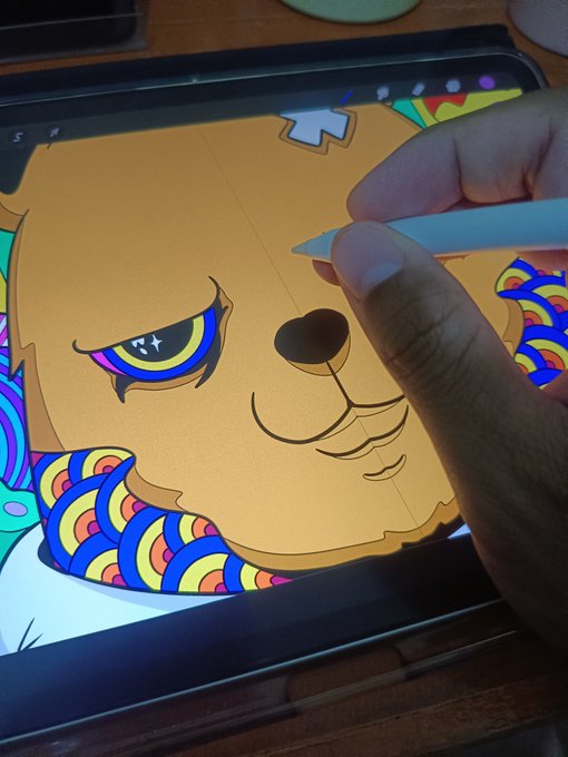 Hand using an Apple Pencil on a tablet to digitally color a stylized cartoon dog illustration with colorful rainbow patterns.