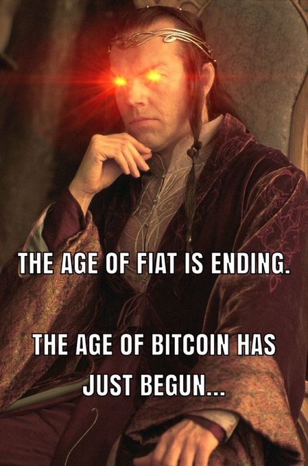 A meme featuring Elrond from Lord of the Rings with glowing red eyes (typically used to signify powerful foresight or prophecy), overlaid with the text "THE AGE OF FIAT IS ENDING. THE AGE OF BITCOIN HAS JUST BEGUN..."

The caption humorously frames the "GM" (Good Morning) post as a prophetic declaration, using Elrond's all-knowing gaze to lend gravitas to the classic crypto evangelist take that fiat currency's era is over and Bitcoin's dominance is imminent.