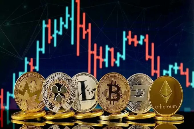 An arrangement of various cryptocurrency coins, including Monero, Ripple, Litecoin, Bitcoin, Dash, and Ethereum, displayed against a backdrop featuring a red and green candlestick trading chart.