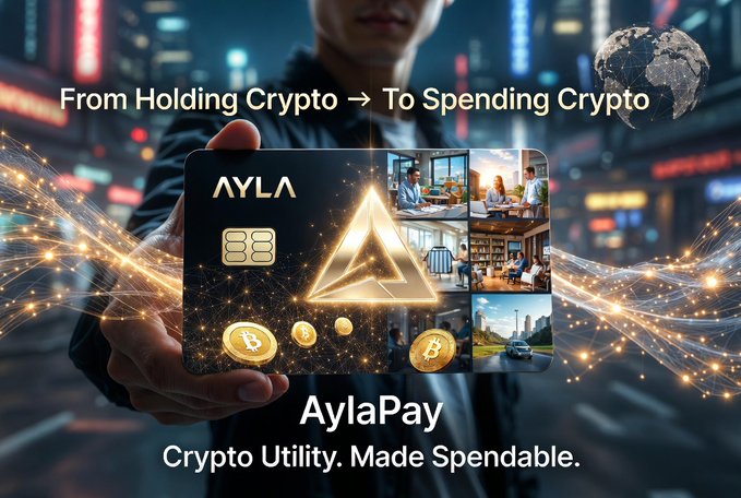 A person holds an "AYLA" branded payment card featuring Bitcoin imagery against a neon-lit city backdrop, with the text "From Holding Crypto → To Spending Crypto" and "AylaPay - Crypto Utility. Made Spendable." The visual reinforces the post's message by showcasing how Ayla transforms crypto holdings into a tangible, spendable card for everyday use.