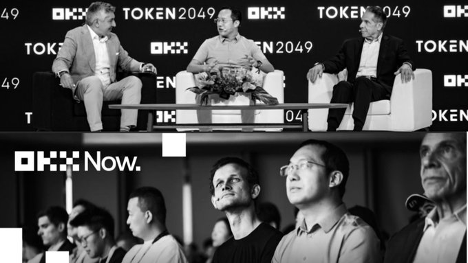 A black-and-white image showing a panel discussion at 'TOKEN2049' and 'OKX' featuring three men seated on a couch, with a separate section below showing audience members and the text 'OKX Now.'