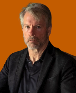 The image shows a man sitting down with a serious expression. In front of him there are two thumbs up signs, indicating some sort of approval or agreement. The backdrop is an orange color, which provides contrast for the man's facial features and emphasizes his profile. The caption on the image refers to "Saylors strategy sold 32 Bitcoins strategy sold 32 $BTC for around $$$2.5 million in the past week" and asks how it relates to the post.