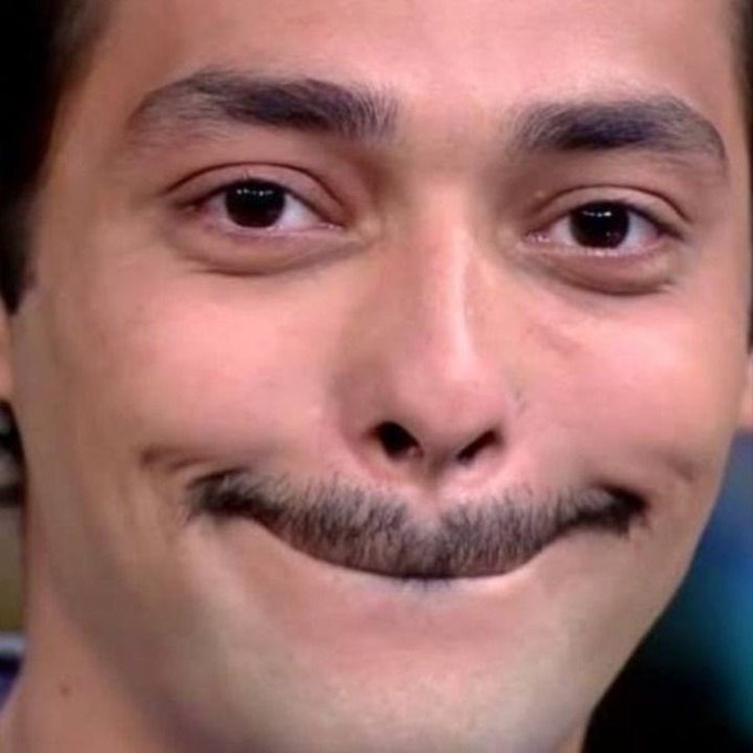 A close-up of a man's face with a subtle, mischievous smirk fits the caption's tone of wanting to stir up some playful trouble in a quiet timeline.