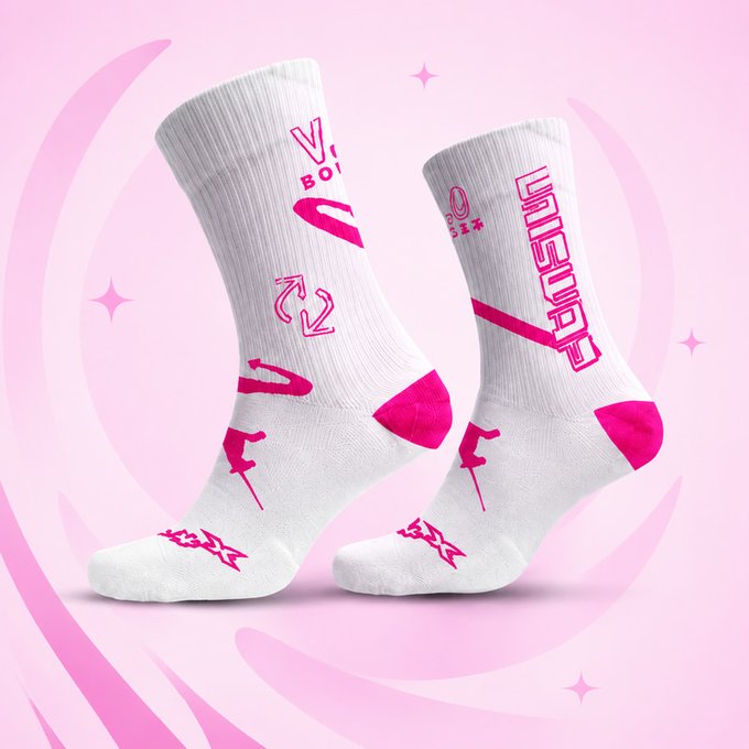 A pair of white crew socks featuring bright pink graphics, text reading "VIBE BOX" and "UNSTOPPABLE," and lightning bolt and recycling symbol designs, displayed against a pink background with sparkle accents.