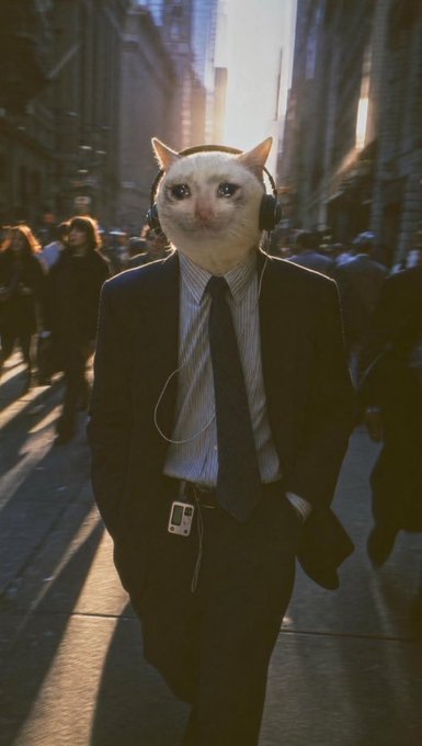 A surreal image of a figure wearing a black business suit, white striped shirt, dark tie, headphones, and a white cat's head, walking down a sunlit city street.