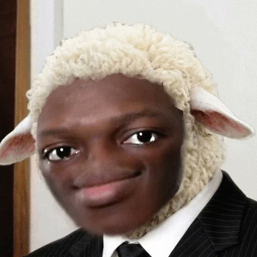 A photoshopped image showing a young man in a suit and tie with the head of a sheep, displaying a slight smile.