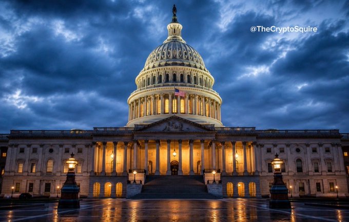 The image features a night view of the U.S. Capitol building under a dramatic, cloudy sky, symbolizing the legislative setting where bills like the CLARITY Act are discussed. The photo includes the watermark "@TheCryptoSquire" in the upper right corner.