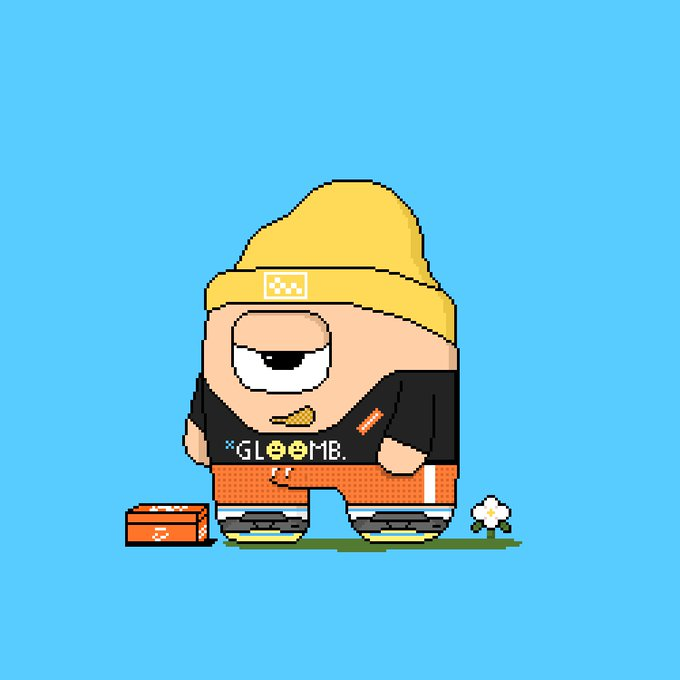 This image depicts a cartoonish  bear with a laid-back demeanor, wearing a yellow beanie with a Puma logo, a black hoodie with "GLOOMB" written across the front, and red pants. The accompanying message, "GM NFT lovers are we still gloomble?" suggests a connection to NFT communities and uses a play on words with "GLOOMB" to reference a common greeting ("GM" likely stands for "good morning") within the digital currency and NFT enthusiast circles.