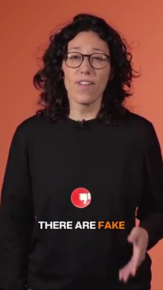A woman with curly hair and glasses speaks against an orange background, with text reading "THERE ARE FAKE" displayed below a graphic of a tooth-like icon, illustrating a warning about counterfeit Ledger Wallet applications.
