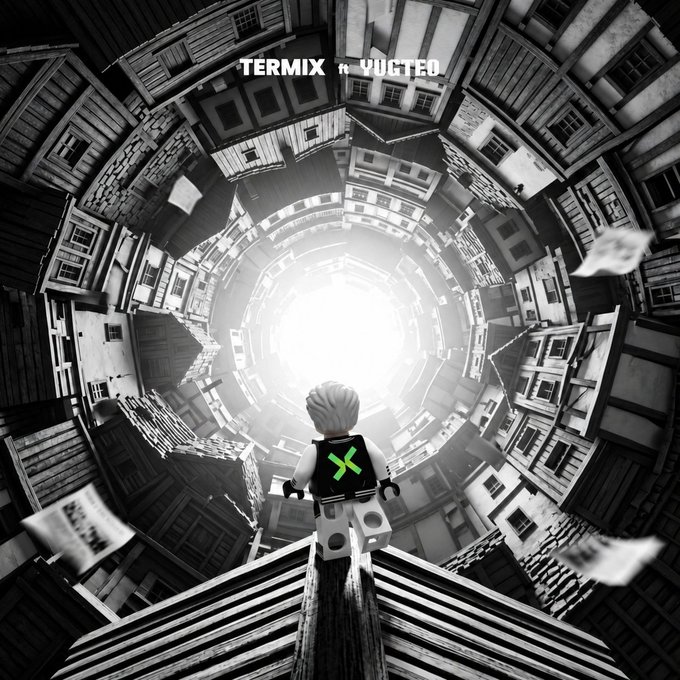 A black-and-white surreal artwork titled 'TERMIX ft VUCTED' showing a LEGO figure wearing a backpack with a green X emblem standing on a beam, looking down into a spiraling vortex of buildings and floating papers.