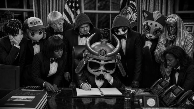 A hooded figure in a horned samurai helmet signs a document at the Resolute Desk while surrounded by a diverse team of costumed characters—including a money mascot, a fox-masked figure, and a hooded silver entity—representing "Gods Chosen Casino" boldly declaring their underdog defiance against industry giants.