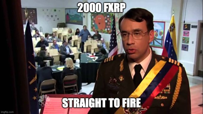A man in a Venezuelan military uniform with a yellow, blue, and red sash stands prominently in the foreground while people hold up boxes in the background, captioned "2000 FXRP" above and "STRAIGHT TO FIRE" below. The meme references a 2000 FXRP (Flare XRP) cryptocurrency transaction being directed straight to a "fire" address (a burn address used to permanently remove tokens from circulation).