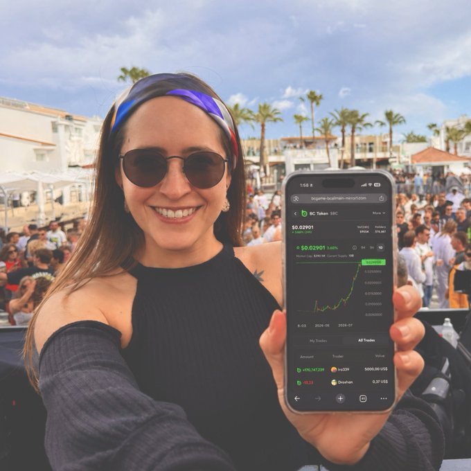 A smiling woman in sunglasses and a headband holds up her phone displaying "BC Token" at $0.02901 with an upward-trending chart, while standing in a crowd at an outdoor palm tree-lined venue—visually celebrating the token's new all-time high referenced in the post.
