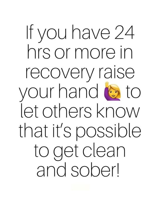 The image features an inspirational message in black text on a white background, reading: "If you have 24 hrs or more in recovery raise your hand 👋 to let others know that it's possible to get clean and sober!" Accompanied by a waving woman emoji, the image promotes recovery and connects to the hashtags #Recoveryispossible and #RCVRY by encouraging those in recovery to share their success and inspire others on a similar journey.