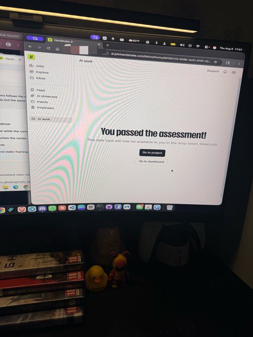 A computer monitor displays a web page reading 'You passed the assessment' on a platform called Handshake, indicating the completion of a career-related task type.