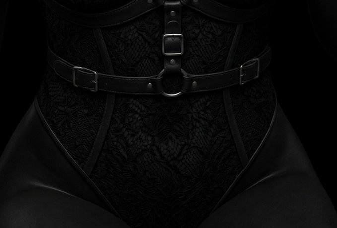 A close-up, monochromatic black image focusing on a person's torso wearing a black lace bodysuit with multiple leather straps and silver buckles across the waist and hips.