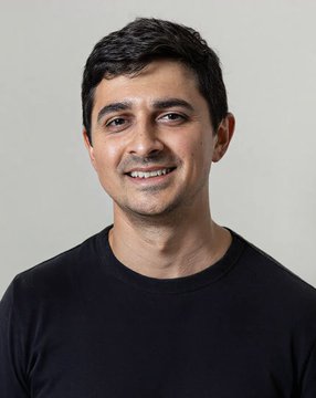 A portrait photo of a man with dark hair and a mustache, smiling and wearing a black t-shirt against a plain light background, representing a Solana Foundation executive referenced in the post about a recent 5x market interaction.