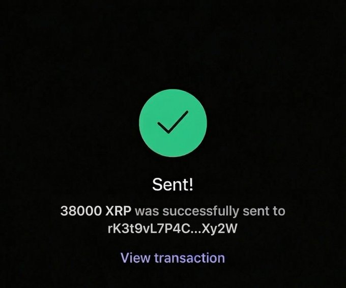 The image shows a message screen with an XRP symbol and a thumbs up sign. The text indicates that the sender successfully sent $38,000 to another person who has never won any raffle prizes before.