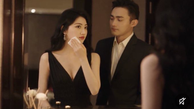 A woman in a black dress dabs her face while standing beside a man in a suit in an upscale setting. The image's glamorous, polished aesthetic mirrors the post's critique of Jing Tian's "short-term trading mindset," suggesting superficial focus on quick gains rather than long-term fundamentals like studying Justin Sun's strategy.
