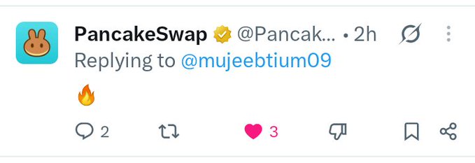 A screenshot of a tweet from the official verified PancakeSwap account (@Pancak...) replying to @mujeebtium09 with a single fire emoji 🔥.