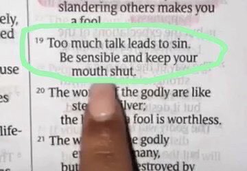A Bible verse from Proverbs chapter 19 is circled in green marker, reading 'Too much talk leads to sin. Be sensible and keep your mouth shut,' with a finger pointing at the text.