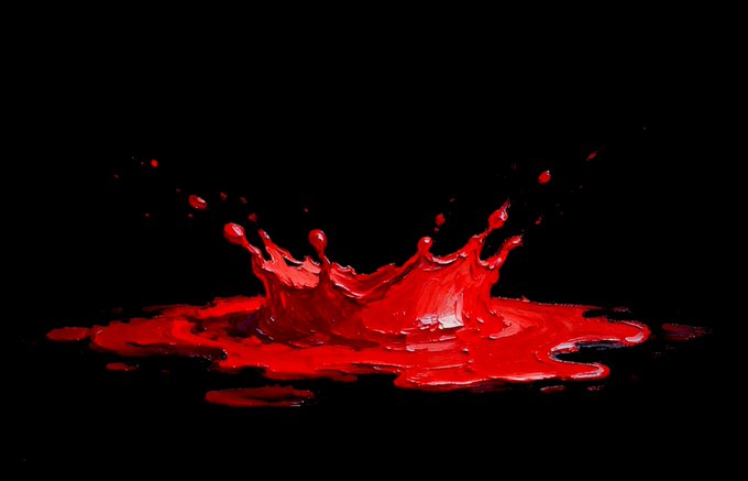 A vibrant red liquid splashes dramatically against a black background, with droplets caught mid-air forming a crown-like shape above a pool of the fluid.