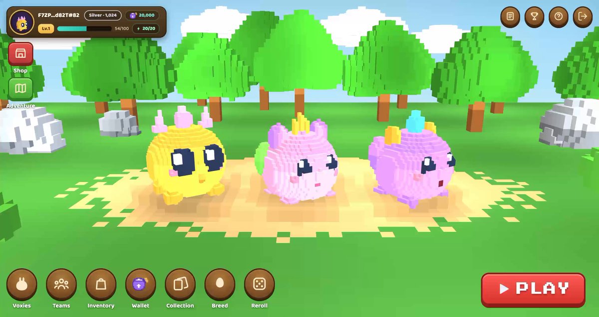 The image shows an advertisement for a video game called "Voxie Infinity", which features three cute cartoon characters, two pink ones and one yellow one, sitting together on a dirt surface surrounded by trees. The game's title is displayed at the top of the screen in white text against a brown background.