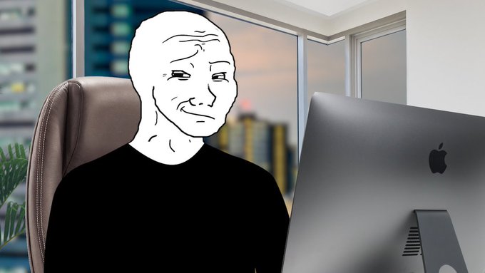 A Wojak-style cartoon figure sits in front of an Apple iMac with a city view through the window, looking at the screen.