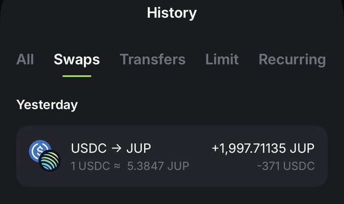 A mobile app history screen showing a 'Swaps' tab with a transaction converting USDC to JUP: +1,997.71135 JUP for -371 USDC at a rate of 1 USDC ≈ 5.3847 JUP.