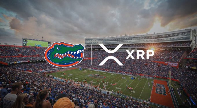 The image shows a packed football stadium at sunset with the Florida Gators logo overlaid next to the XRP cryptocurrency logo (showing its distinctive "X" symbol and ticker text). The accompanying post suggests the University of Florida Gators have announced a major partnership with the XRP cryptocurrency, though the stadium and logos are composited together as promotional imagery rather than depicting an actual announcement.
