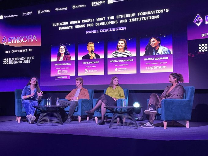 A panel discussion at 'ETH SOFIA DEV CONFERENCE OF BLOCKCHAIN WEEK BULGARIA 2026' titled 'BUILDING UNDER CROPS: WHAT THE ETHEREUM FOUNDATION'S MANDATE MEANS FOR DEVELOPERS AND INSTITUTIONS', featuring four speakers on stage.