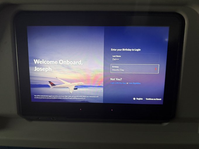 An airplane seatback screen displaying a welcome message 'Welcome Onboard, Joseph' with a Delta aircraft graphic and a login prompt asking for a birthday.