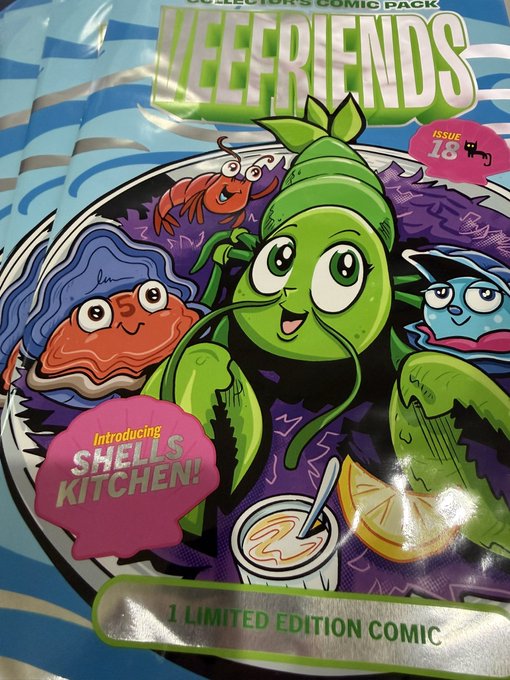 A close-up photograph of a 'VEEFRIENDS Collector's Comic Pack' featuring colorful cartoon sea creatures, with text indicating 'ISSUE 18,' 'Introducing SHELLS KITCHEN!', and '1 LIMITED EDITION COMIC'.