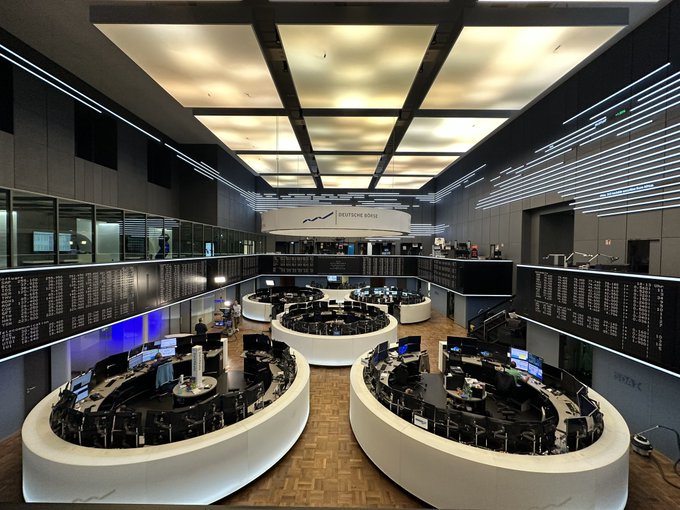 A modern Deutsche Börse trading floor with curved white workstations and illuminated ceiling panels. The image likely depicts the Frankfurt Stock Exchange where the Bitwise ETP tracking NEAR was launched.