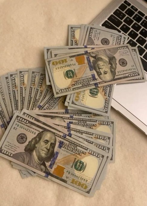 Stacks of $100 bills fanned out next to a laptop keyboard, embodying the post's "Let's get rich together" theme with visible serial numbers like "PB 36442328 B" and the bold "100" denominations on the currency.