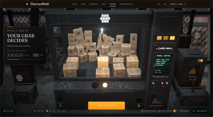 A video game interface for "TheCardWall" featuring a claw machine filled with cardboard boxes, with text reading "YOUR GRAB DECIDES," "MANUAL CONTROL: MOVE THE CLAW, PICK YOUR DECIDES," and a "DROP THE CLAW" button.