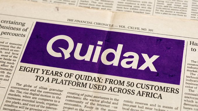 A close-up of a newspaper front page from "THE FINANCIAL CHRONICLE — VOL. CXLVII, NO. 301" featuring a large purple header for "Quidax" with the headline "EIGHT YEARS OF QUIDAX: FROM 50 CUSTOMERS TO A PLATFORM USED ACROSS AFRICA."