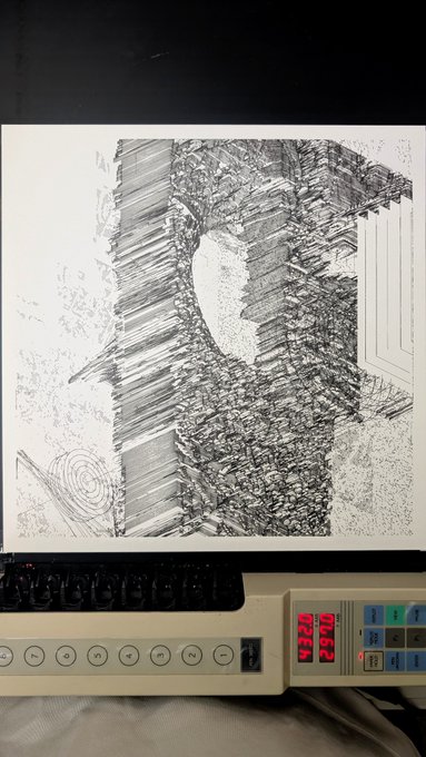 A black and white abstract ink drawing on paper sits above a control panel displaying red digital numbers reading '3290'.