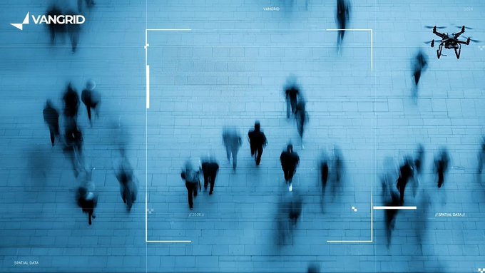 A Vangrid promotional image showing an aerial view of blurred pedestrians walking, with a drone and targeting reticle overlay reading '// SPATIAL DATA'.