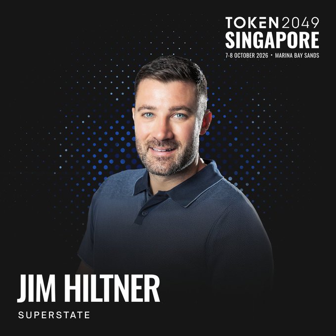 A promotional graphic for TOKEN 2049 SINGAPORE featuring a headshot of a smiling man in a dark polo shirt, with text reading '7-8 OCTOBER 2026 • MARINA BAY SANDS' and 'JIM HILTNER SUPERSTATE'.