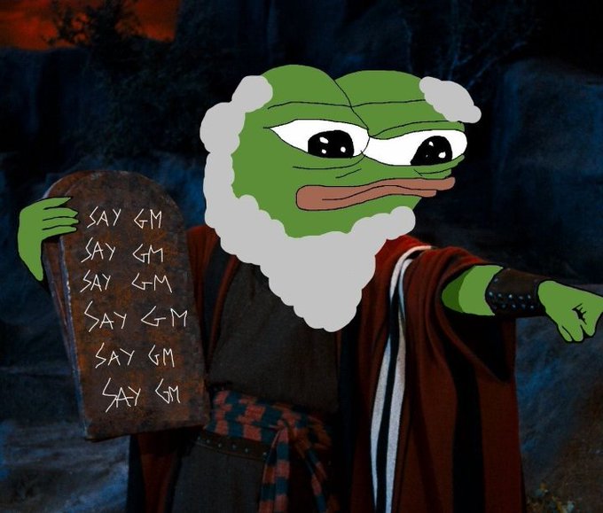 A meme image of the Pepe the Frog character edited onto a Moses-like figure holding two tablets inscribed with 'SAY GM' six times, pointing outward.
