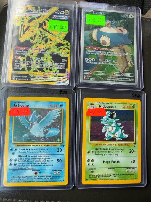 Four graded Pokémon trading cards displayed in protective cases, including Rayquaza V (PRIMO), Snorlax (115), Articuno (70 HP), and Nidoqueen (90 HP), with handwritten prices like "$90" and "$40.00."