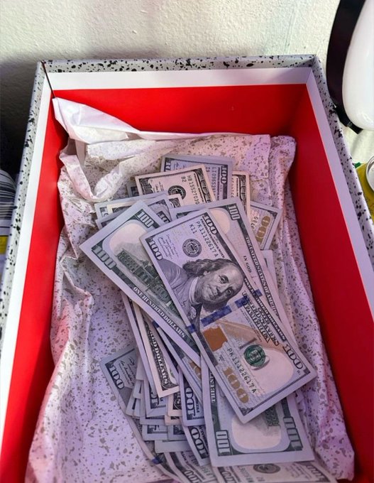 A shoebox overflows with $100 bills, from the US currency, visually reinforcing the statement "We're making money this year".
