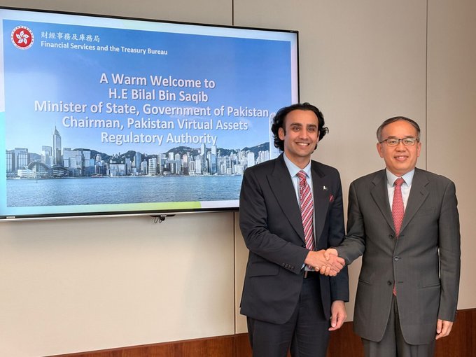 Two men in suits shaking hands in front of a screen welcoming 'H.E Bilal Bin Saqib, Minister of State, Government of Pakistan, Chairman, Pakistan Virtual Assets Regulatory Authority' at the Financial Services and the Treasury Bureau.