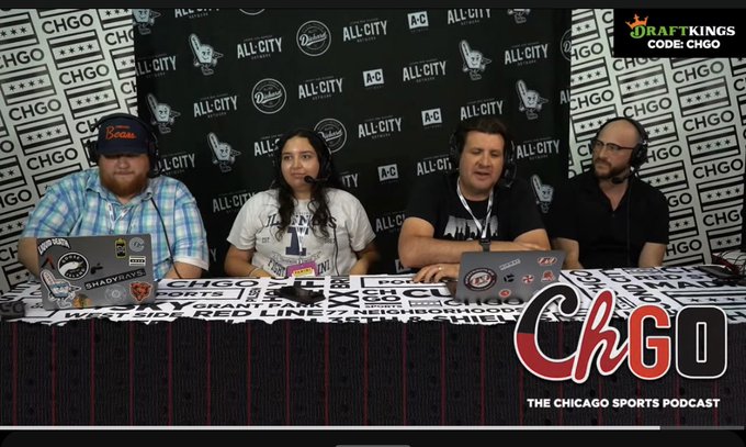 Four people sit at a table with laptops and microphones during a CHGO podcast recording, with a backdrop featuring "ALL CITY," "Chicago," and a "DraftKings code: CHGO" promotion in the corner. The caption relates to the image as it shows the CHGO_Sports podcast mentioned in the post, where the speaker previously appeared to discuss NBA TopShot and digital fandom.